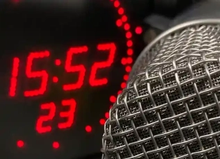 Detailed view of a professional microphone in a recording studio environment.