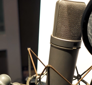 Condenser microphone set up in a professional recording studio, ready for a recording session.