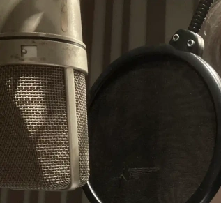 close-up of a condensor microphone in a recording studio.
